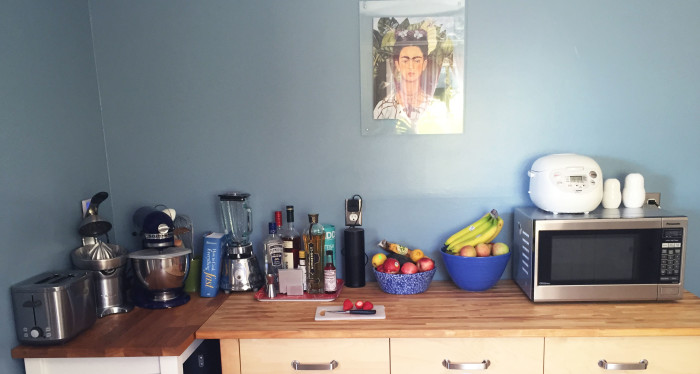 A view of my kitchen counter with strawberries and Frida Kahlo.