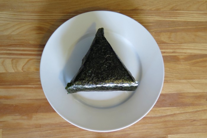 One piece of salmon onigiri on a plate. 